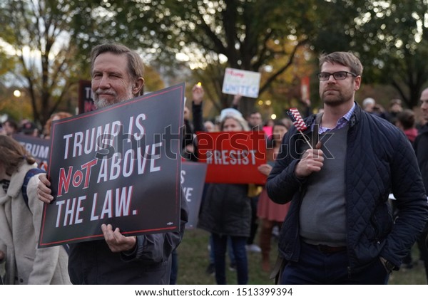       Washington, DC/USA – November 8, 2018: A\
demonstrator in Lafayette Square at the White House holds a sign\
reminding President Trump that he is not above the law.            \
            