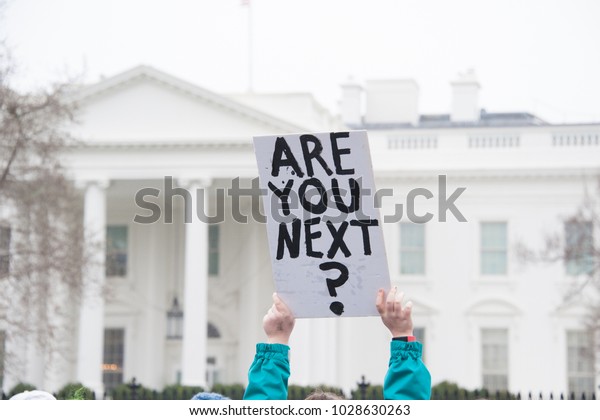 WASHINGTON FEBRUARY 19:  A protester holds a sign\
protesting gun laws at the White House on February 19, 2018 in\
Washington DC