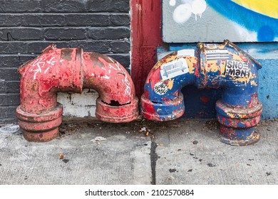 Washington Heights, Manhattan, New York City, New York, USA. November 4, 2021. Vent pipes on a sidewalk in Washington Heights.