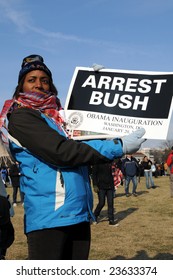 WASHINGTON - JAN 20: An Unidentified Demonstrator Holds A Sign Demanding The Arrest Of U.S. President George Bush At The Inauguration Of U.S. President Barack Obama On January 20, 2009 In Washington.