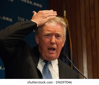 WASHINGTON - MAY 27, 2014 - Real estate mogul Donald Trump demonstrates that the hair on his head really is his, at a National Press Club luncheon.
