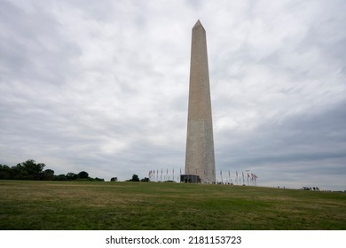 The Washington Monument, a 555-foot-tall obelisk-shaped building within the National Mall towering over Washington, DC, against a cloudy sky. - Powered by Shutterstock