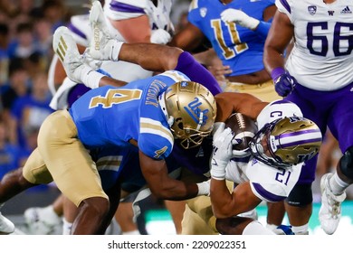 Washington Running Back Wayne Taulapapa (21) Is Brought Down By UCLA Defensive Back Stephan Blaylock (4) During An NCAA College Football Game Friday, Sept. 30, 2022, In Pasadena, Calif. 