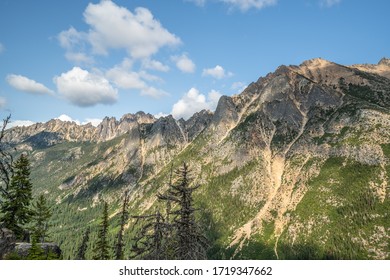 The Washington Section of the Pacific Crest Trail in the North Cascades with view of cloud covered rocky mountains.