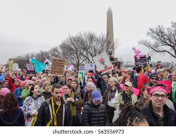 WASHINGTON,DC - JAN 21, 2017: Women's March on Washington, marchers pass Washington Monument in background, part of gigantic turnout that flooded DC in an anti-inauguration show of solidarity.