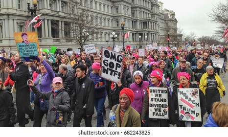 WASHINGTON,DC - JAN 21, 2017: Women's March on Washington, marchers on 17th St. near White house, EOB in background, part of gigantic turnout that flooded DC in an anti-inauguration show of solidarity