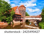 Wasserturm tower, Weinstadel medieval house and Henkerbrucke bridge at Pegnitz river in Nuremberg old town. Nuremberg is the second largest city of Bavaria state in Germany.