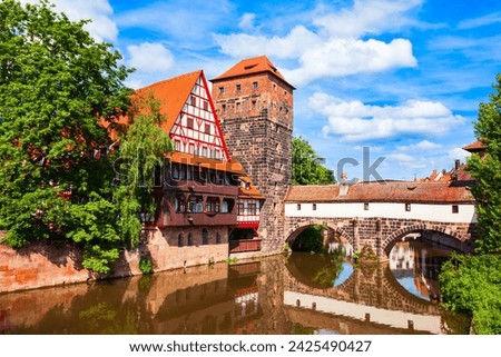 Wasserturm tower, Weinstadel medieval house and Henkerbrucke bridge at Pegnitz river in Nuremberg old town. Nuremberg is the second largest city of Bavaria state in Germany.