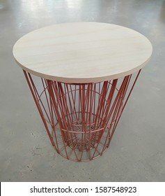 A Waste Basket Placed On A Cement Floor.background