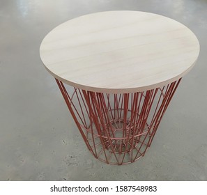 A Waste Basket Placed On A Cement Floor.background