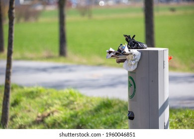 Waste Bin For Dog Faeces Is Overcrowded And Crammed With Plastic Waste And Food Waste, Symbolic Of Environmental Pollution. Horizontal