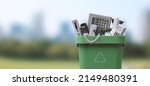 Waste bin full of electronics, e-waste and recycling concept