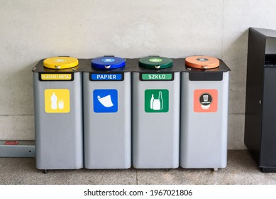 Waste Containers For Garbage Segregation In Poland, Standing Next To A Wall