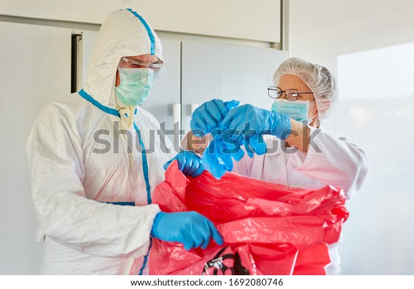 Waste\
disposal in clinic of infectious waste by cleaners in protective\
clothing during Covid-19 coronavirus\
epidemic