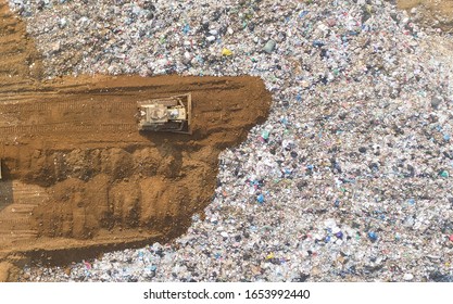 Waste disposal pile of plastic garbage and various trash aerial view by drone.recycling and disposal junk construction.Pollution and waste disposal concept - Powered by Shutterstock
