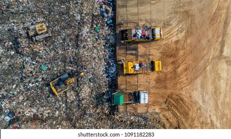 A lot of waste is disposed of in the waste disposal pits. Loaders is working on a mountain garbage. Aerial view and top view. - Shutterstock ID 1091182283