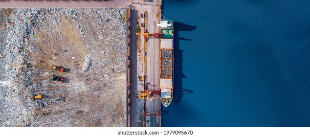 Waste loading at port cargo ship transports of garbage for recycling factory. Concept plastic Pollution environment, aerial top view.