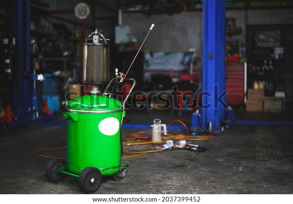 Waste oil\
drains drum tank in garage service\
shop.
