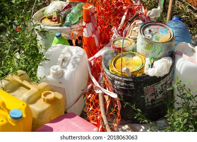 Waste post repair and painting garbage plastic and residues of chemicals lie on the grass, environmental pollution with toxic substances, bad ecology - Shutterstock ID 2018063063