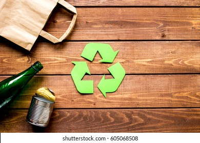 waste recycling symbol with garbage on wooden background top view mockup - Shutterstock ID 605068508