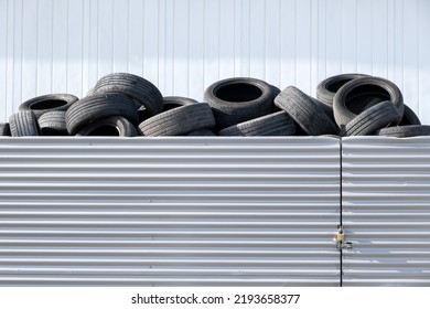 Waste rubber tires at landfill for recycling. Regenerated reuse of the waste car tyres. Pile of old wheels on tyre dump for recycling. Disposal of waste tires. Copy space.