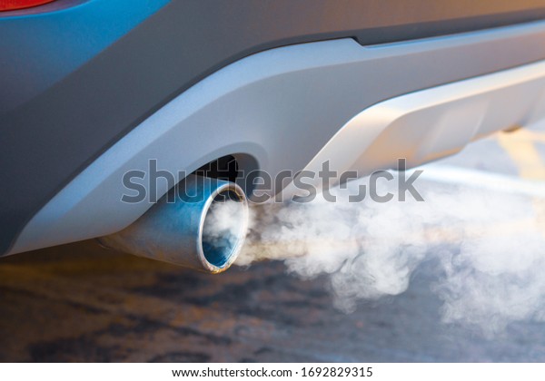 Waste smoke, the crisis of urban air pollution\
from car diesel exhaust on the road. Concept: transport or health\
prevention air pollution.