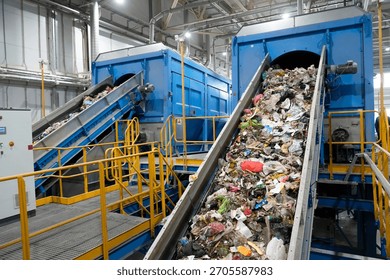 A waste sorting facility operates by separating various types of refuse for recycling. Conveyors carry debris, showcasing an assortment of discarded materials in a clean industrial environment.