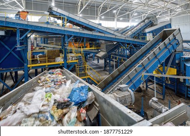 Waste sorting plant. Many different conveyors and bins. conveyors filled with various household waste. - Shutterstock ID 1877751229