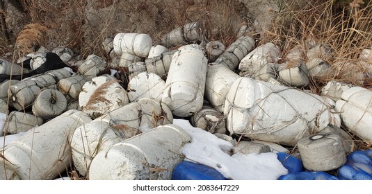 Waste styrofoam buoys are piled up in disorder.