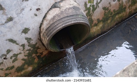 Waste Water Flow To Sewer With Moss, Bad Water From City, Water Pollution, Sewer Drain Pipe Dirt Sewage Water Drain