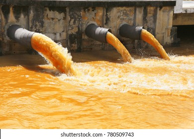 Waste Water Flowing From Metal Pipe  To The River.