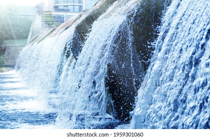 Waste water treatment plant. Modern urban wastewater treatment plant. Cold transparent water of decorative artificial waterfall.