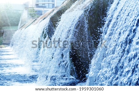 Waste water treatment plant. Modern urban wastewater treatment plant. Cold transparent water of decorative artificial waterfall.