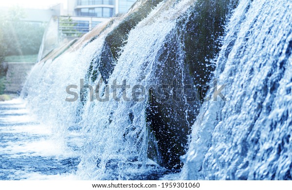 Waste water treatment plant. Modern urban\
wastewater treatment plant. Cold transparent water of decorative\
artificial waterfall.