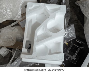 Waste of white styrofoam packaging material for electronic goods in a plastic bag.