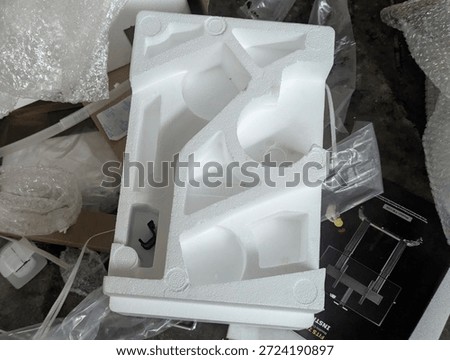 Waste of white styrofoam packaging material for electronic goods in a plastic bag.