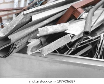 Waster metallic container bin with full with rubbish on factory in workshop. Metal scrap. Recycling - Shutterstock ID 1977036827