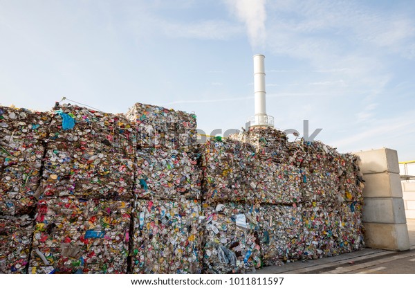 Waste-to-energy or energy-from-waste is the process\
of generating energy in the form of electricity or heat from the\
primary treatment of waste. Cubes of pressed metal beer and soda\
cans.