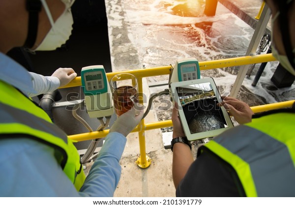 Wastewater treatment concept. Service engineer on \
waste water Treatment plant and checking oxygen in water with\
tablet.  Wastewater treatment concept. Service engineer on waste\
water Treatment\
plant.
