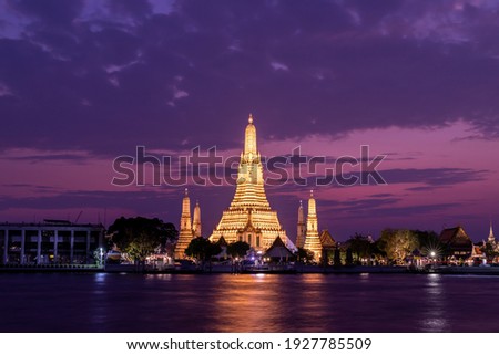 Wat Arun Ratchawararam Ratchawaramahawihan Public Landmark in Bangkok in sunset time with reflections on water Night shot.