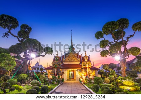 Wat Arun Temple at sunset in bangkok Thailand. Giants front of the church at Wat Arun. Wat Arun is a Buddhist temple in Bangkok Yai district of Bangkok, Thailand