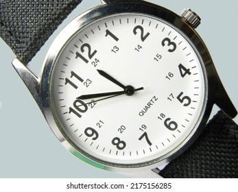 Watch From Above. A Fashionable, Trendy, Stylish And High End Mens Wristwatch. Closeup Watch Face In Studio Isolated Against A Grey Background. Set Your Alarm, Be Early Or On Time And Never Late