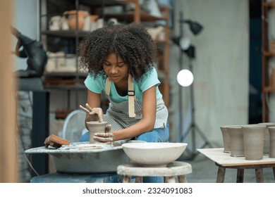 Watch in awe as an African American boy unleashes his craftsmanship, delving into the art of clay handwork, forging a path of artistic pursuit in the ceramic studio. - Powered by Shutterstock