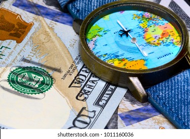 Watch with global map on cash money. World map clock. Worldwide business concept. Cash banknotes background. Global business. Worldwide business travel. Emerging market profit. Economy globalisation