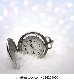 Watch lying in the snow before the new year - Shutterstock ID 114203080