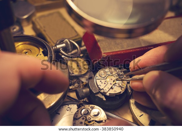 A watch\
maker repairing a vintage automatic\
watch.