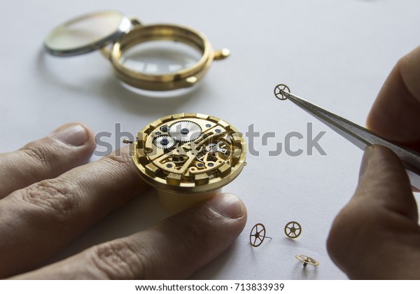 Watch maker\
is repairing a vintage automatic\
watch.