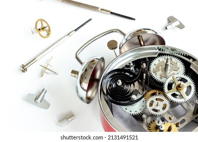 Watch Mechanism And Watchmaker Tools Near Open Alarm Clock