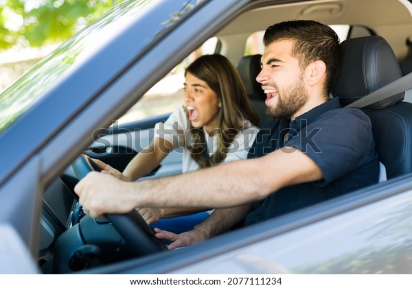Watch out! Scared couple\
trying to avoid an accident after a car or passerby that got on the\
road