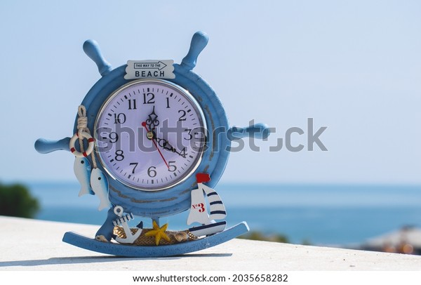 A watch, a souvenir from the summer vacation.\
On the clock is the text \